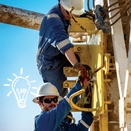 Construction workers on industrial equipment